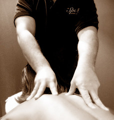 massage masseuse working on woman's back