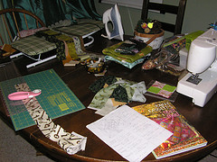 table with sewing machine, quilting supplies