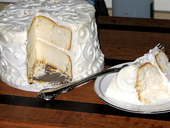 white wedding cake with slice removed