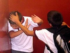 one boy hitting another who is defending himself