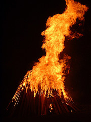 bonfire burning against dark background