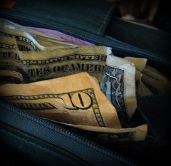 ten and one dollar bills in wallet