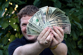 person holding cash all fanned out
